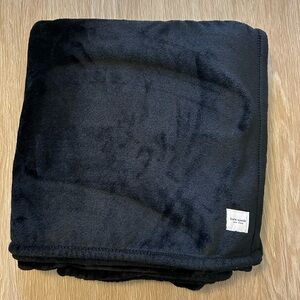 kate spade black plush throw with logo patch